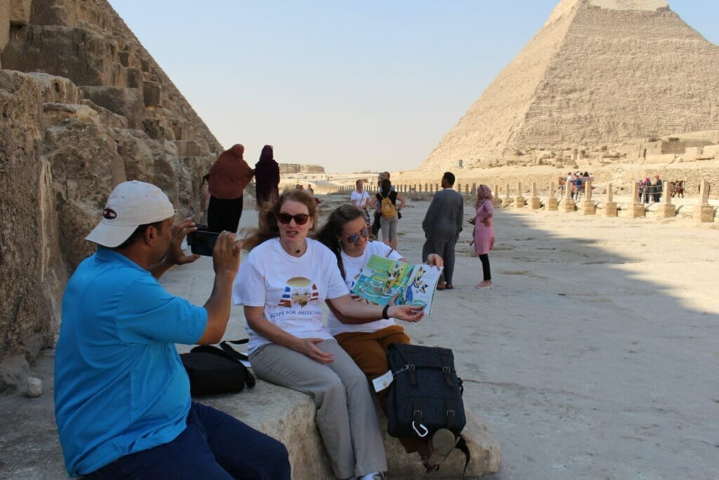 American Teachers at the Pyramids and Sphinx Reading a book to American Students