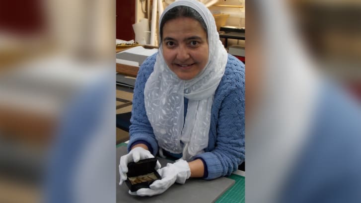 Abeer Eladany with the cigar box and the relics from the Great Pyramid
