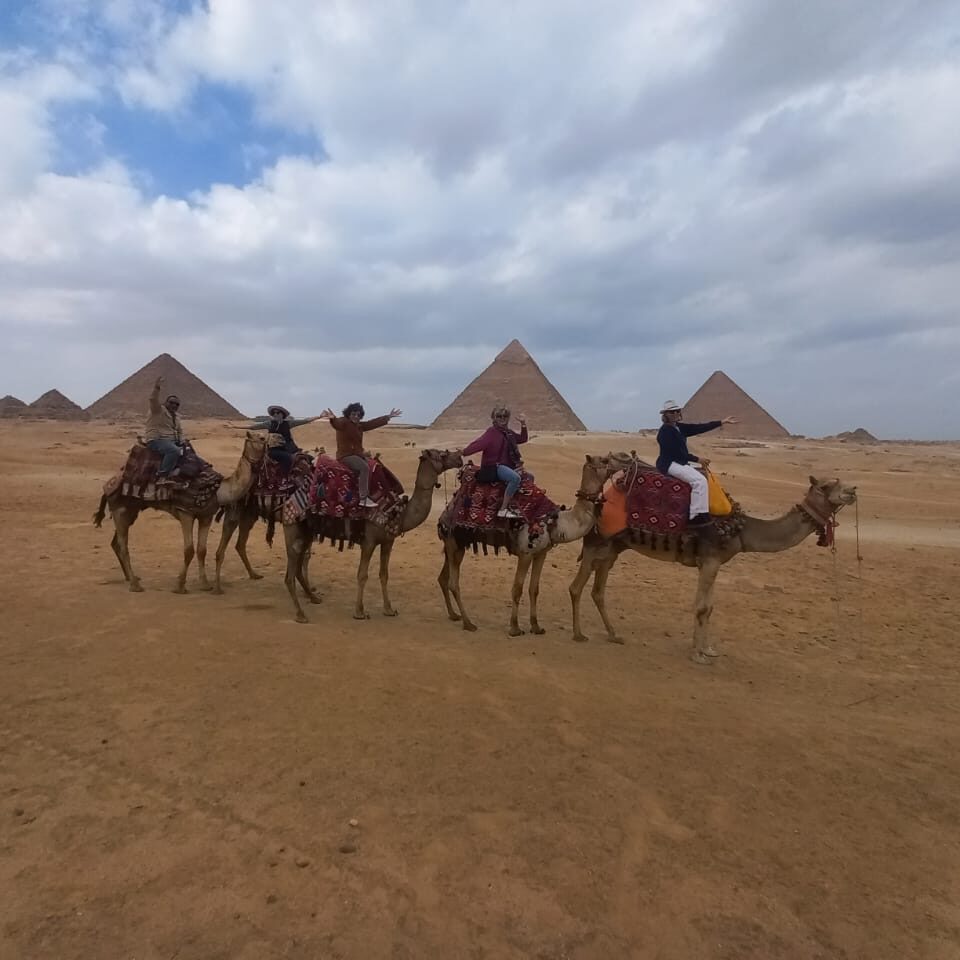 solo female travelers camel ride with the great pyramids of giza